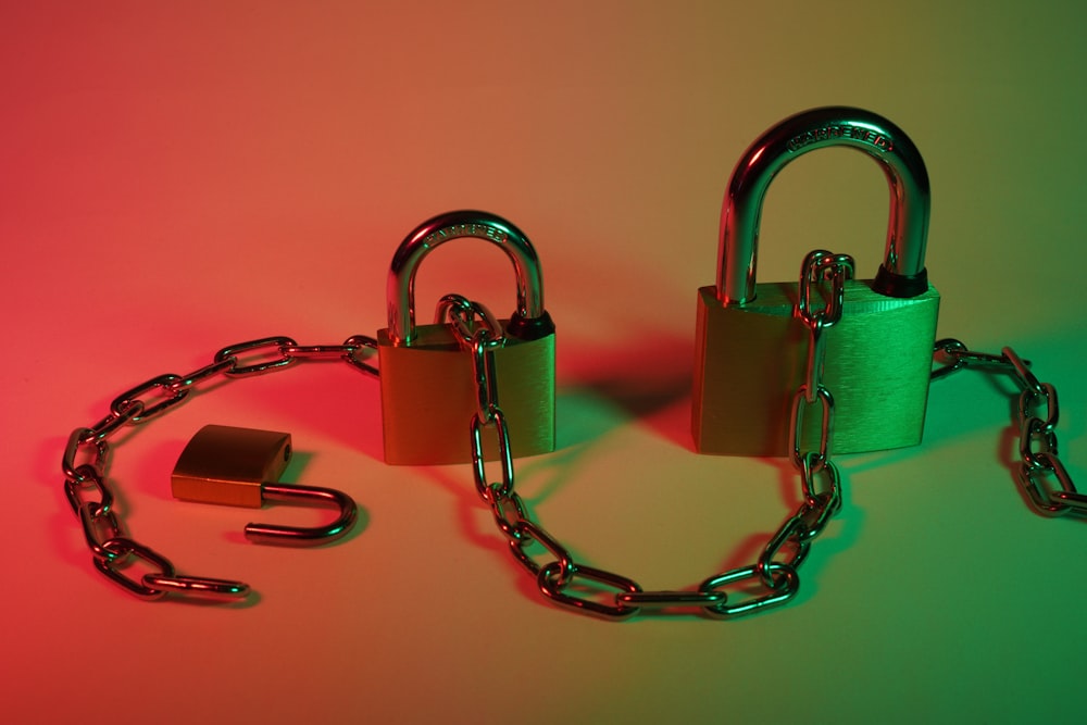 two gray padlock on pink surface