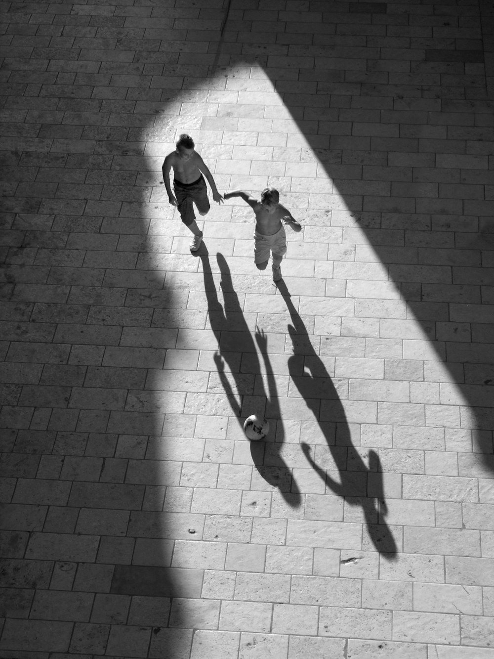 2 men walking on brick pavement