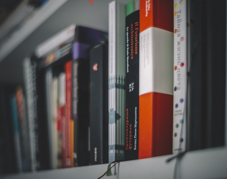 books on white wooden shelf