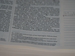 Close-up of hands marking up a manuscript with colorful editing notes.