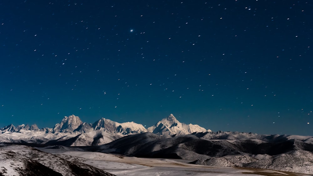 snow covered mountain under blue sky during daytime