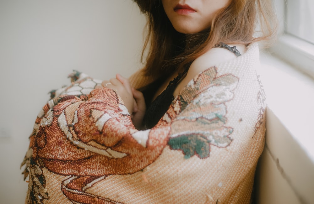 woman in white and brown floral sweater