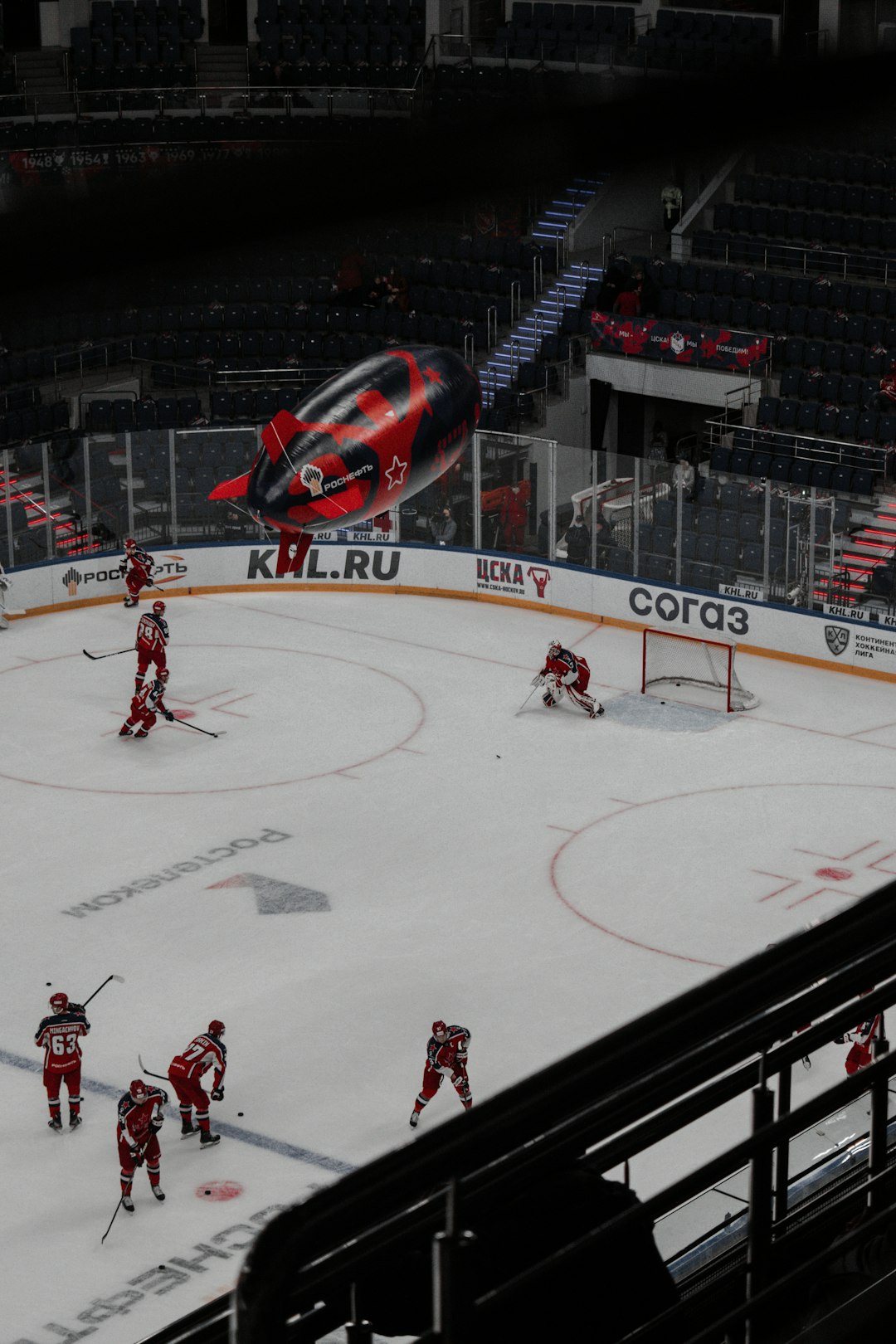 red and black sports car on ice hockey stadium