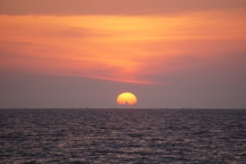 body of water during sunset