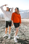 2 women standing on gray rocky ground during daytime