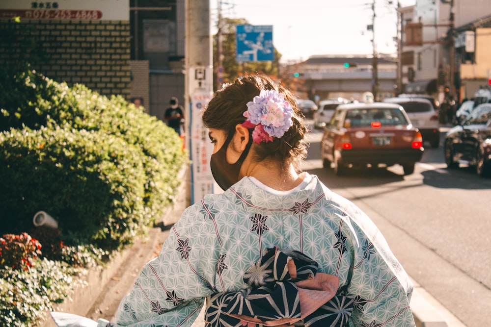 woman in white and black floral long sleeve shirt with pink flower headband