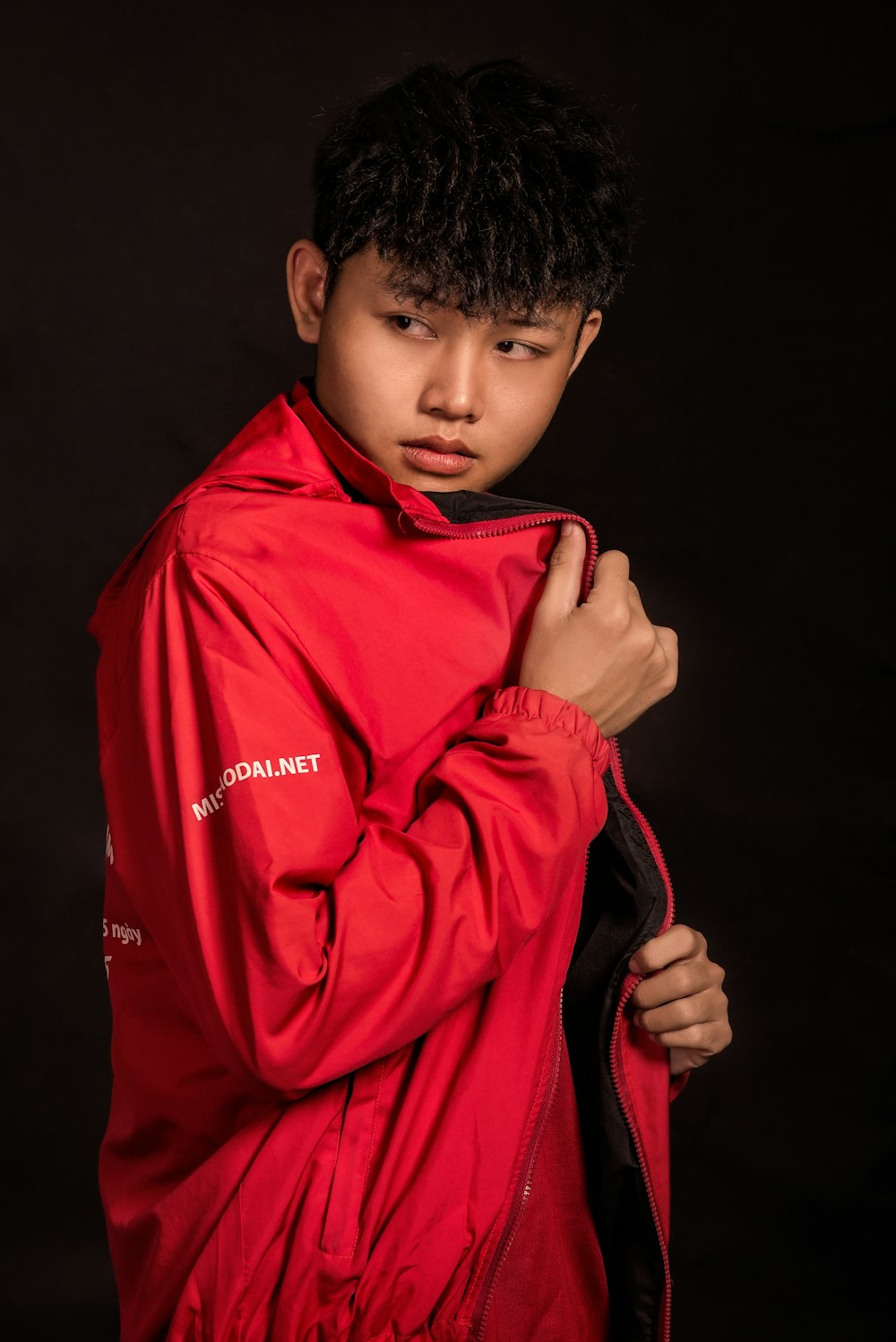 boy in red hoodie covering his face