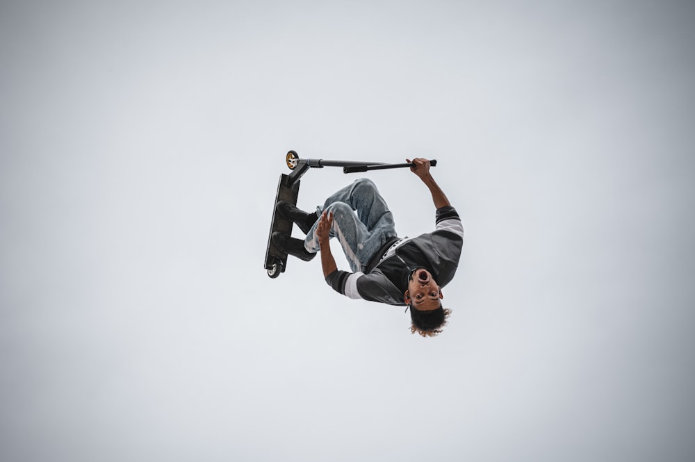 man in blue denim jacket and black pants riding on black skateboard