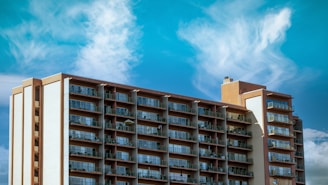 brown and white concrete building under blue sky during daytime