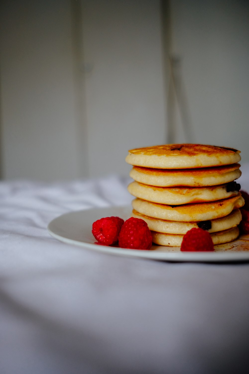 pancakes with strawberries on white ceramic plate