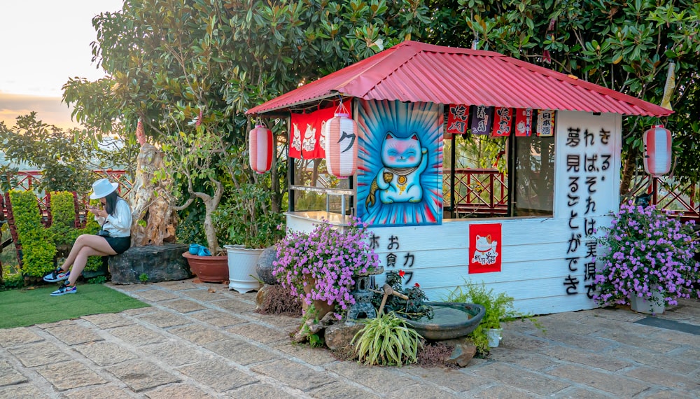 red and white wooden house with green plants