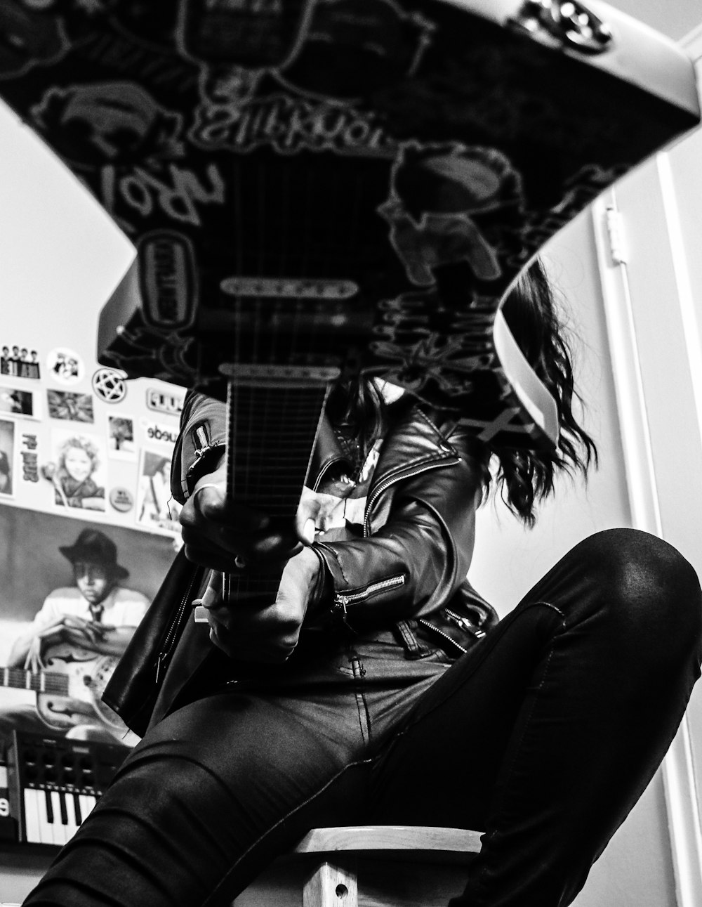 grayscale photo of woman in black pants and jacket sitting on chair