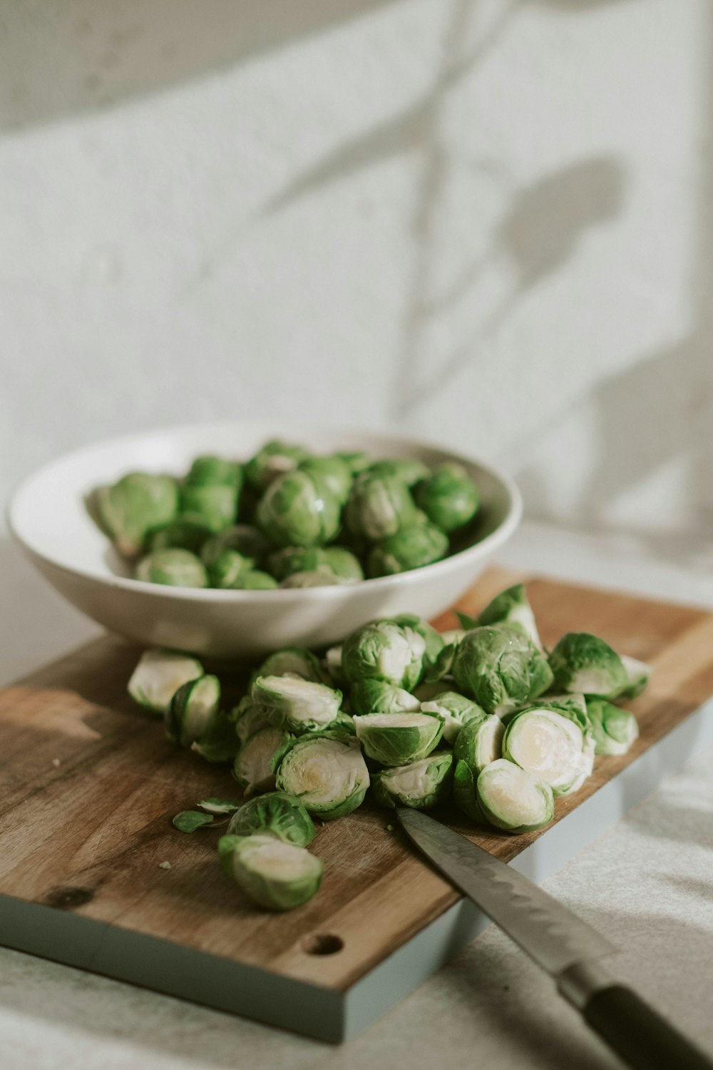 green vegetable on white ceramic bowl