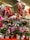 A vibrant display of Valentine's Day-themed decorations featuring an assortment of heart-shaped balloons with romantic messages, surrounded by a variety of potted flowers in colorful containers. The scene is adorned with red and pink hues, emphasizing the festive and romantic atmosphere.