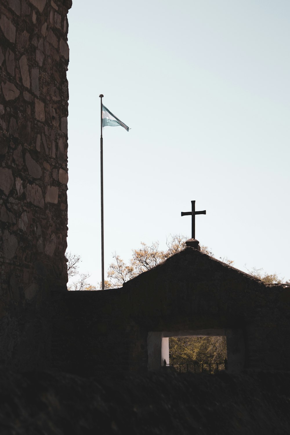 brown brick building with cross on top