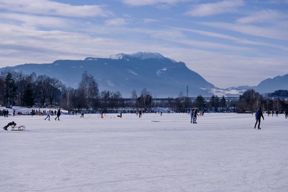 people on snow covered field during daytime