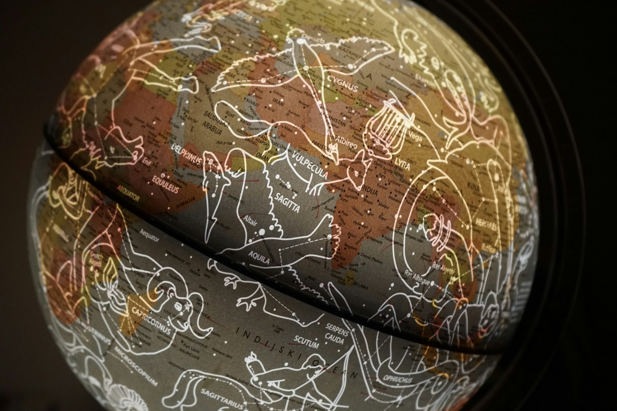 brown and white printed globe with constellations