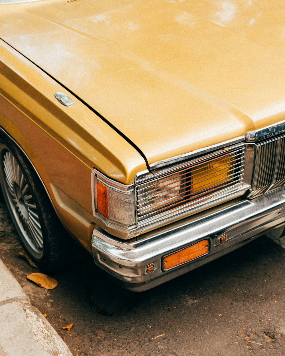 brown car on gray concrete pavement