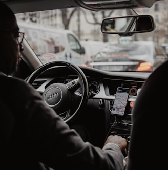 man in black jacket driving car during daytime