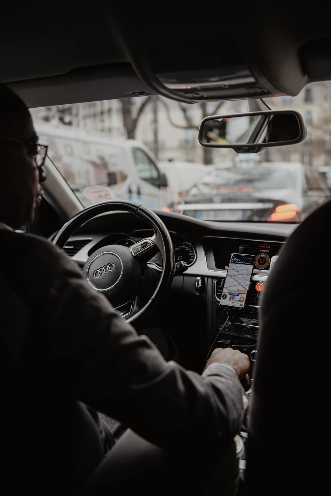 A driver behind the wheel mid-shift, the driver hour a routing system is trying to make productive