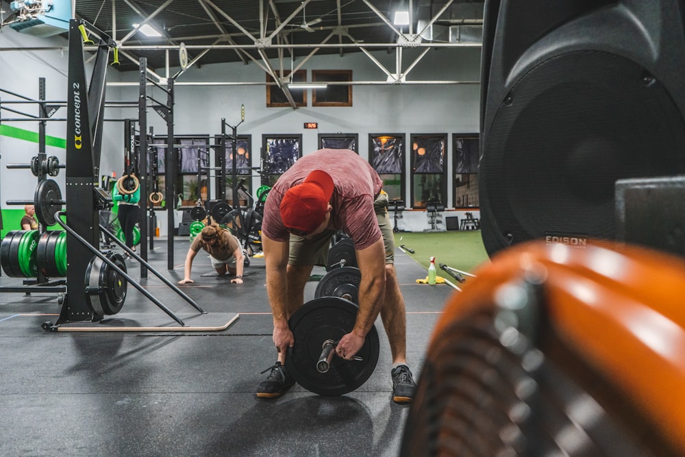 a man squatting down in a crossfit gym