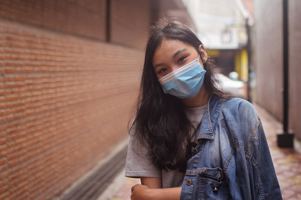 woman in blue denim button up jacket with white face mask
