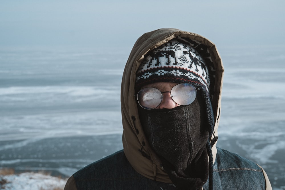 person wearing black and white knit cap and black jacket