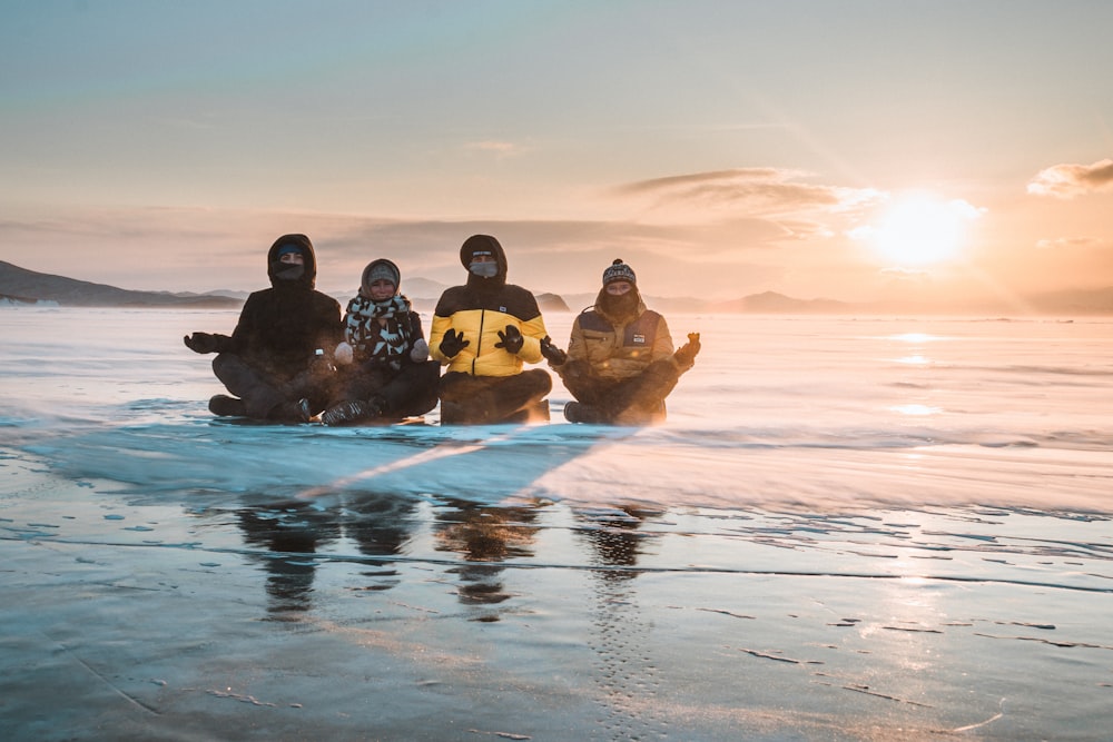people riding on inflatable boat on water during sunset