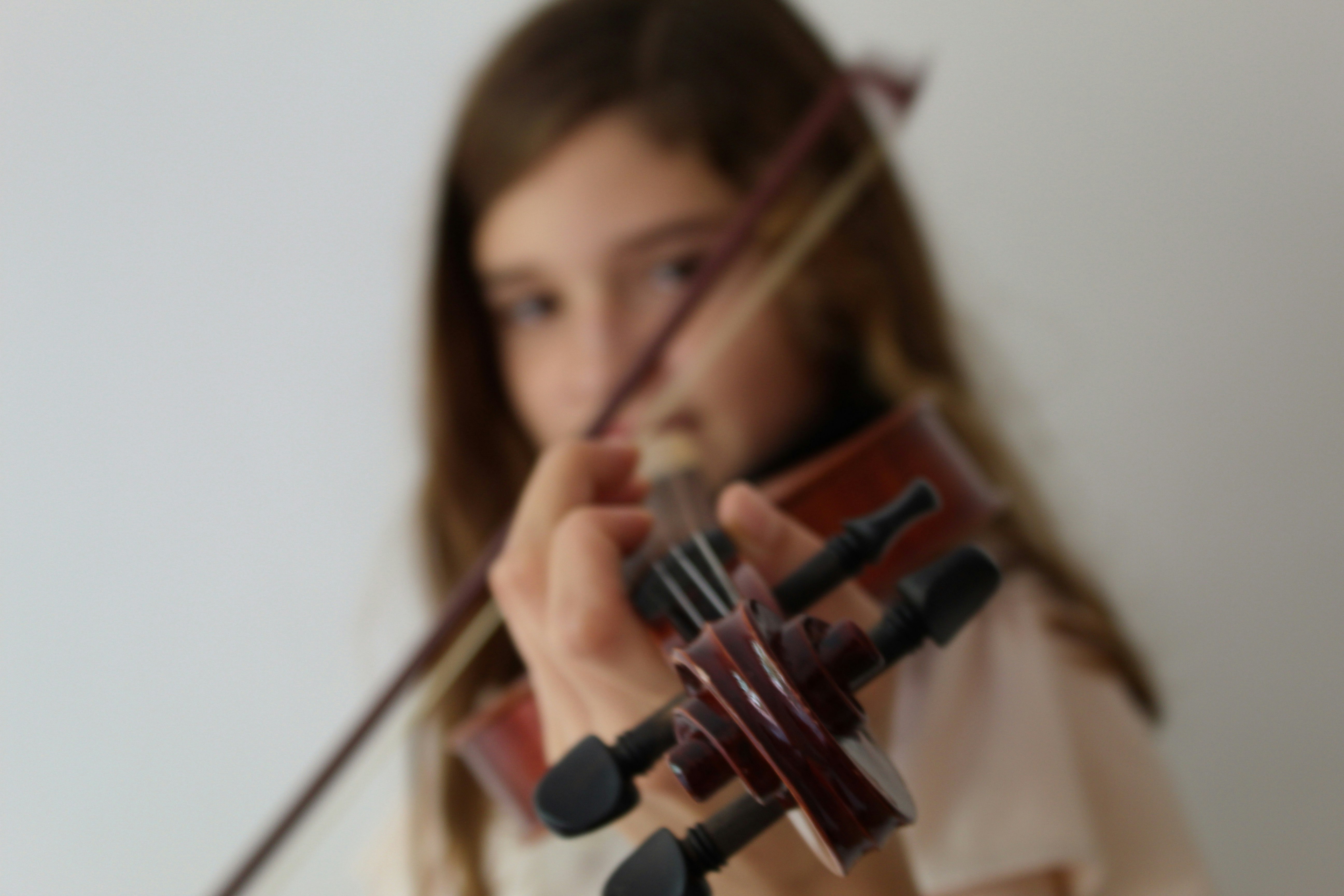 woman playing violin in close up photography