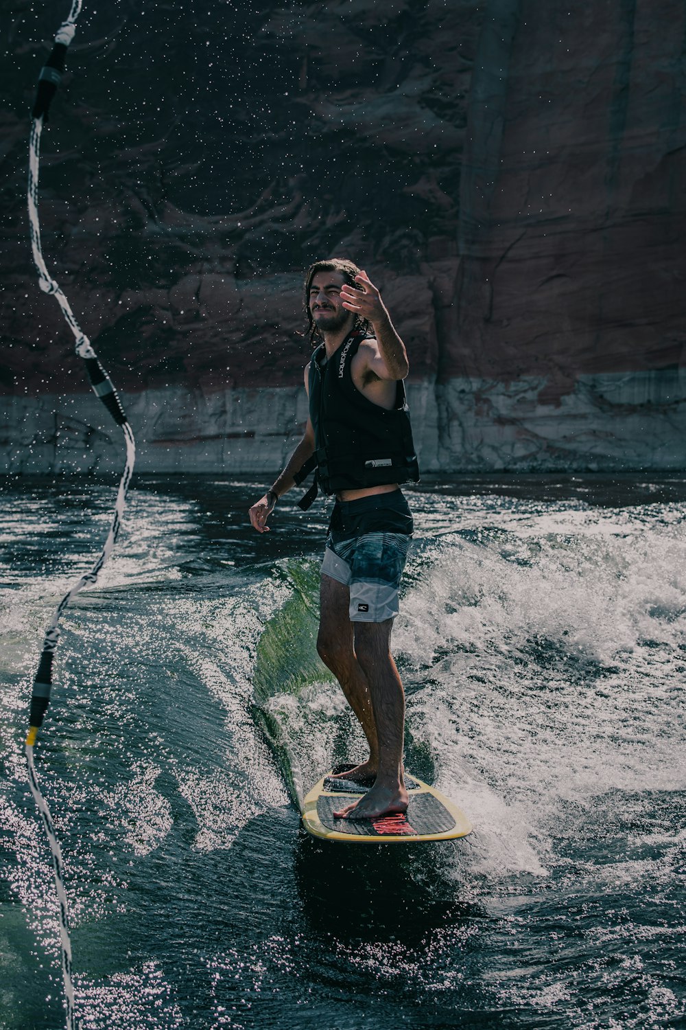 woman in black tank top and blue denim shorts standing on water