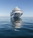 white and blue boat on sea under blue sky during daytime