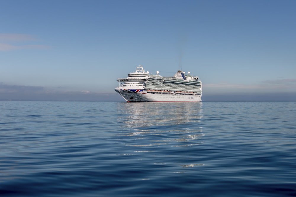 white and black cruise ship on sea under blue sky during daytime