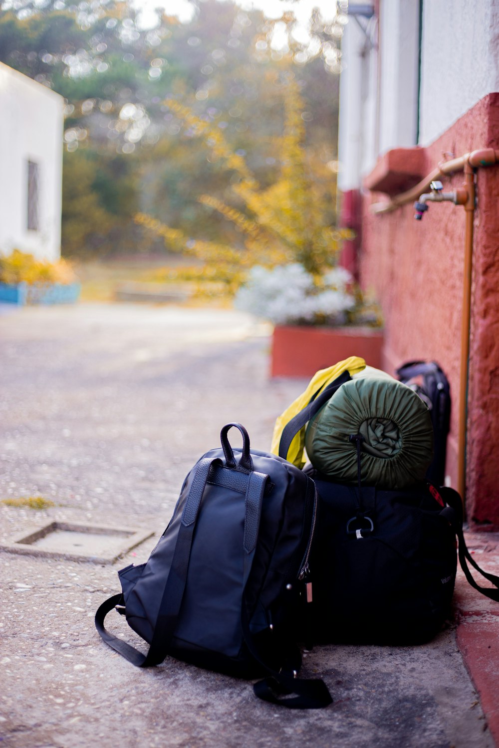 black backpack on gray concrete road