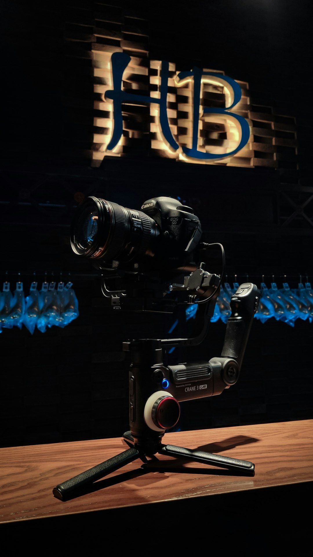 black dslr camera on black and blue audio mixer