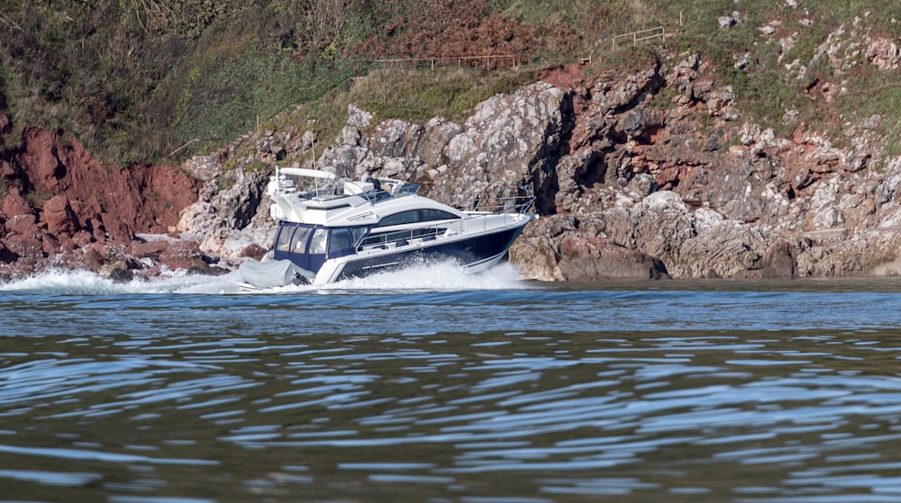 white and black boat on body of water during daytime