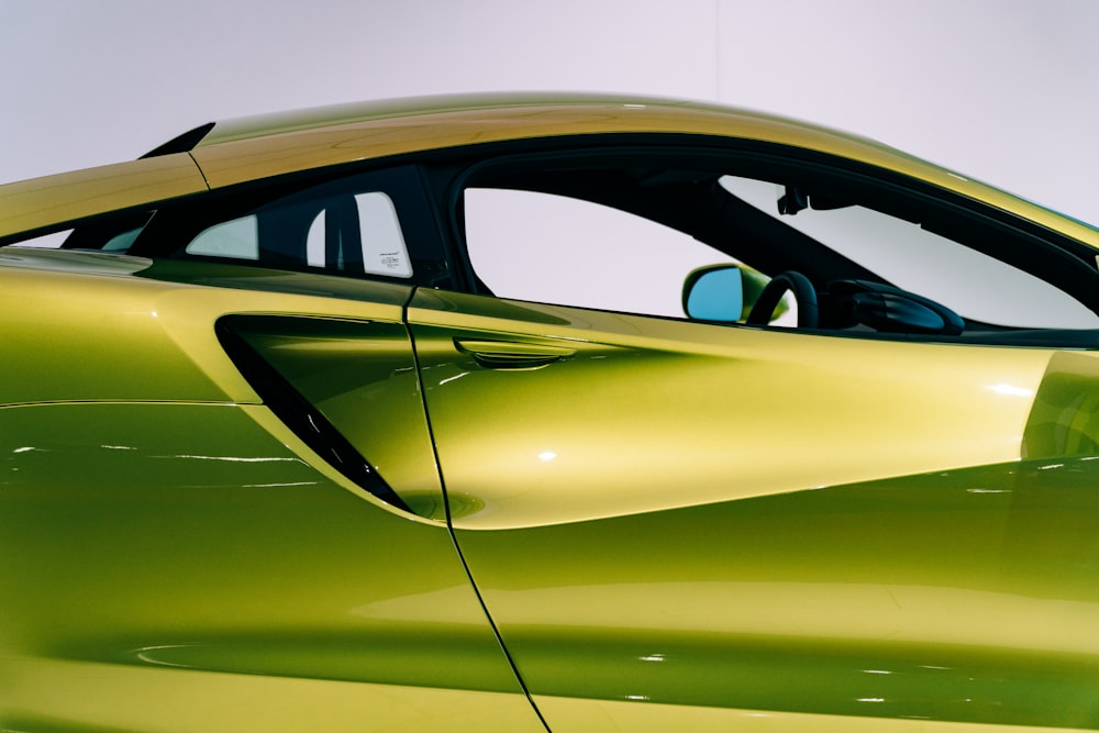 green porsche 911 parked in a room