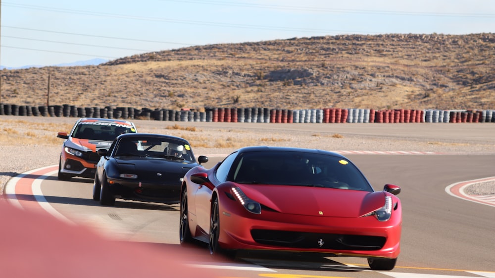 red ferrari coupe on road during daytime