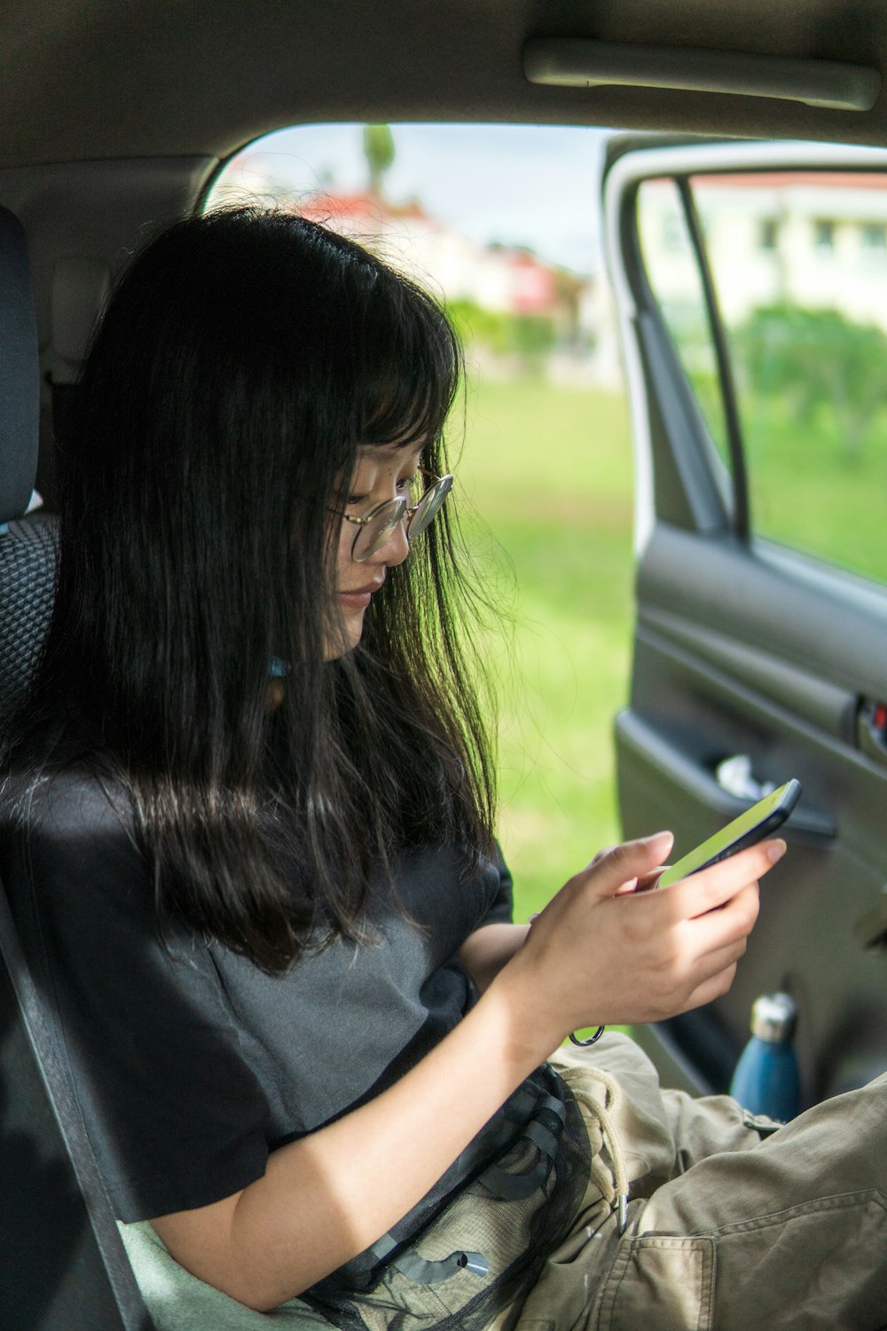 woman in black t-shirt holding smartphone