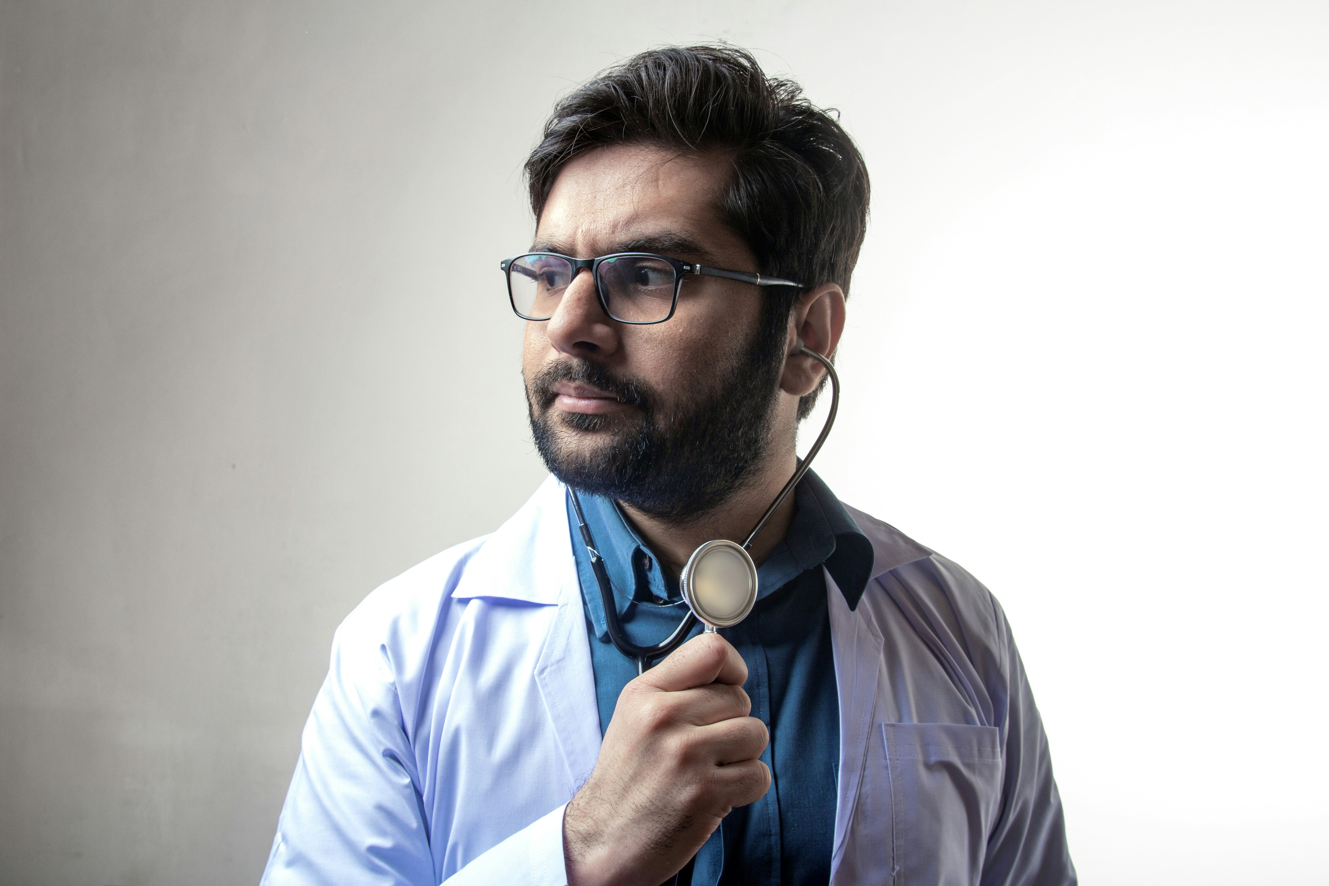 man in blue dress shirt wearing black framed eyeglasses