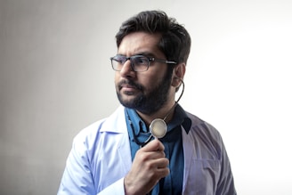 man in blue dress shirt wearing black framed eyeglasses