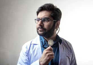 man in blue dress shirt wearing black framed eyeglasses