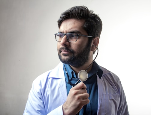 man in blue dress shirt wearing black framed eyeglasses