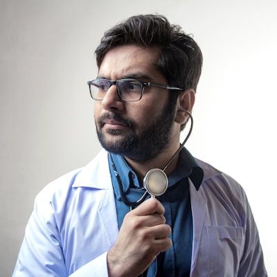 man in blue dress shirt wearing black framed eyeglasses