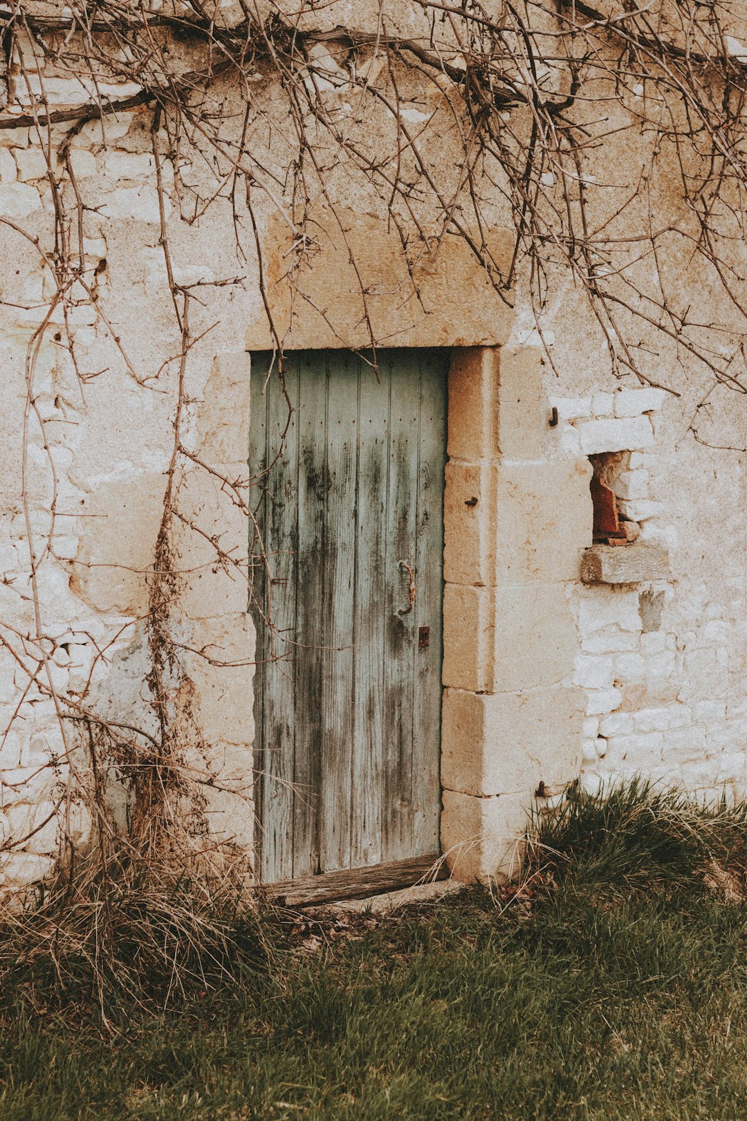 brown wooden door on white concrete wall