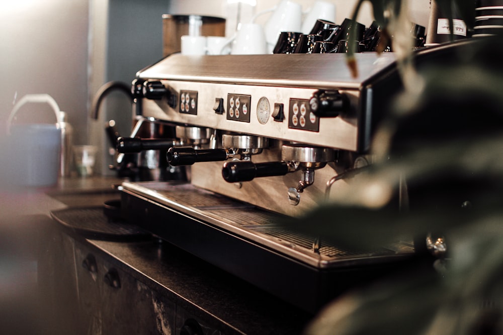silver espresso machine on brown wooden table
