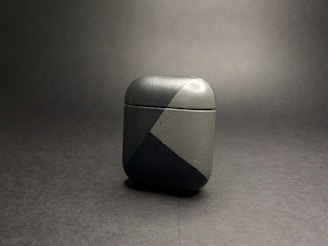 Earpods cases in neutral tones with subtle pink accents, displayed on a clean, modern desk setup.