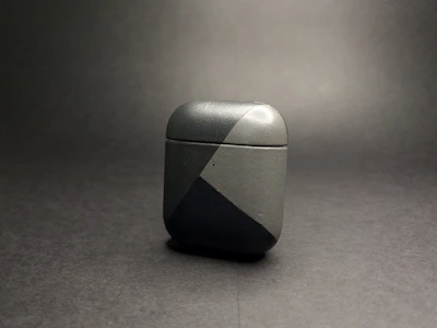 Dust-proof earphone case in sleek matte gray, with precise cutouts visible from the side.