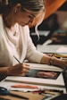 woman in white long sleeve shirt writing on white paper