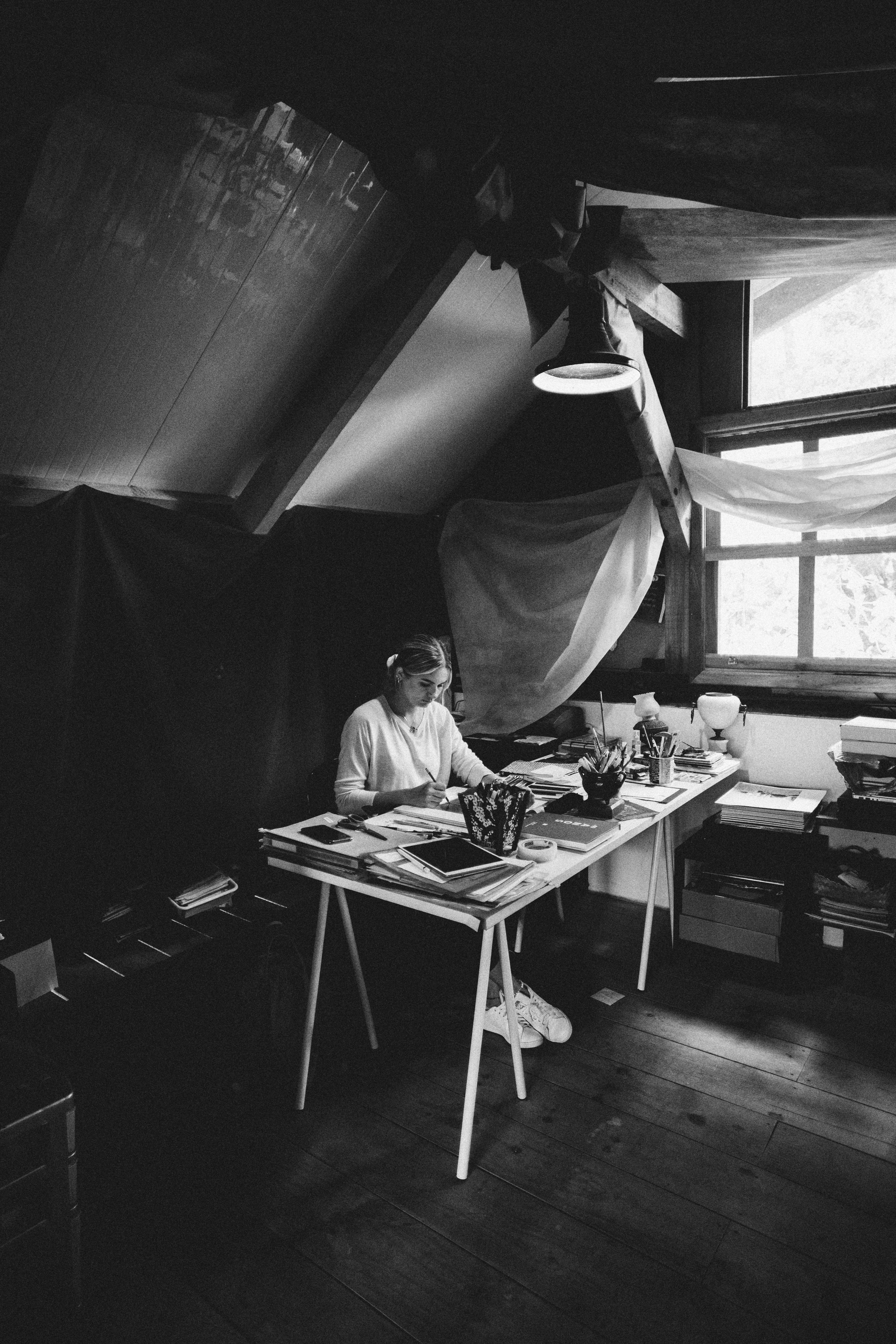 grayscale photo of man sitting on chair