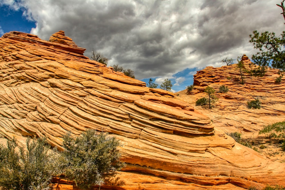 brown rock formation under white clouds during daytime